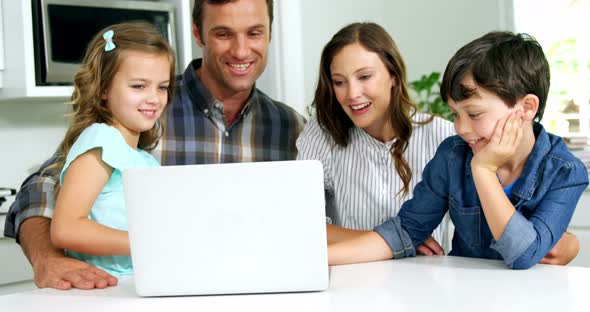 Happy family using laptop