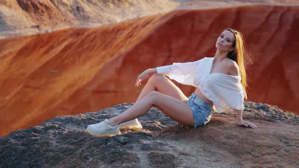 Beautiful woman posing on other-worldly hilly landscape