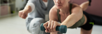 Exercising with Dumbbells in Fitness Studio