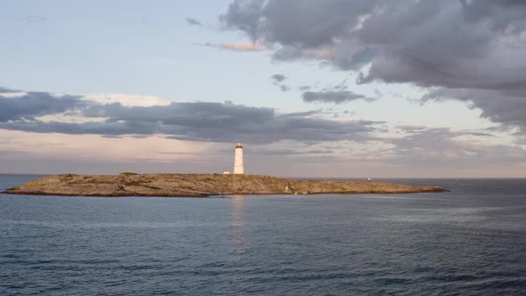 Lille Torungen Lighthouse Against Overcast Sky In Arendal, Norway - aerial drone shot