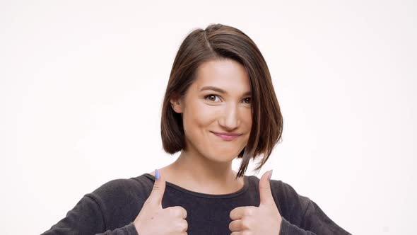 Portrait of Young Pretty Girl Rejoicing and Showing Okay