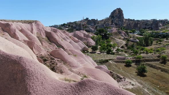 Amazing pink rocks and Uchisar castle in the background at Cappadocia, Turkey