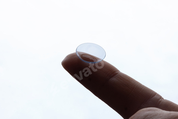 Contact lenses for vision correction. A woman holds a contact lens on her finger, close-up. macro