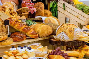 Assortment of fresh baked goods displayed at market in local farmers market