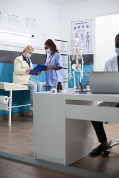 Nurse guides patient at medical checkup