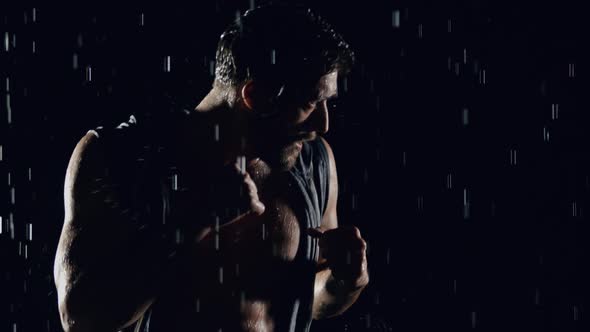 Athletic Man Boxing In The Rain