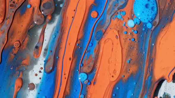 Abstract Close Up Texture of Oil with Orange, Yellow and Blue Paint. Wallpaper