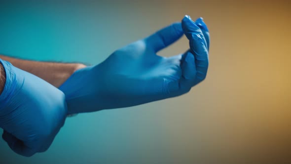 Doctor Putting on Medical Protective Gloves Close Up