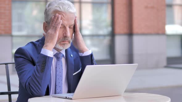 Old Businessman with Headache Working on Laptop Outdoor