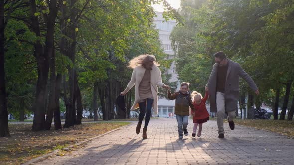 Happy Family Are Walking Together in the Park.