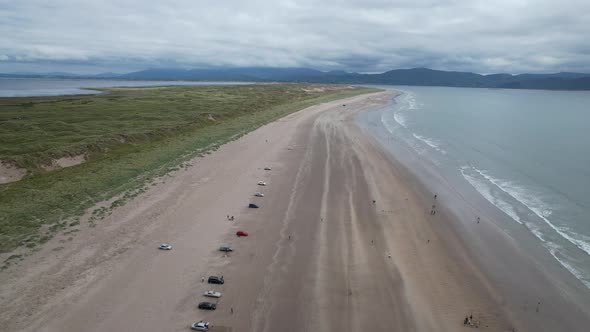 Row of cars parked on Inch beach Dingle peninsula Ireland drone aerial view