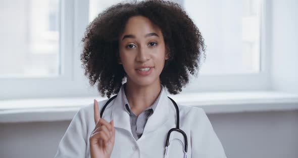 Young Professional African Woman Doctor Wear Uniform with Stethoscope Talk Conference Video Call