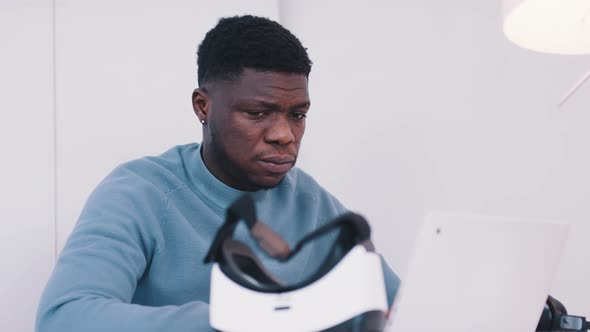 Young African American Black Man Putting on VR Glasses