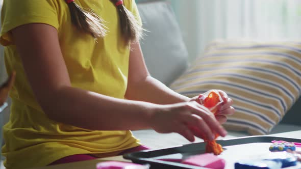 Girl Child Is Taking Plasticine From Package