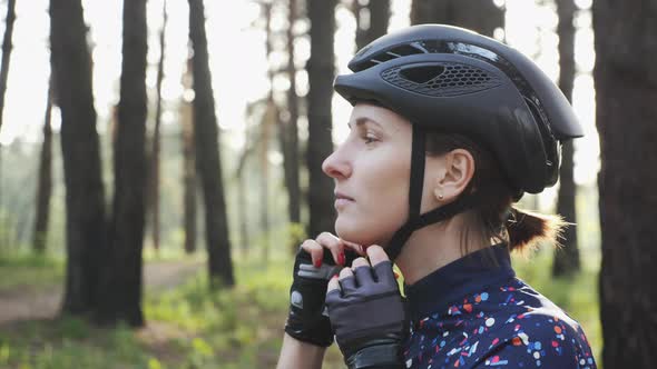 Female cyclist is wearing helmet