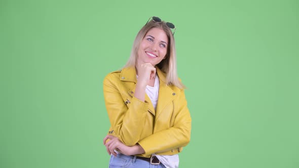 Happy Young Rebellious Blonde Woman Thinking and Looking Up