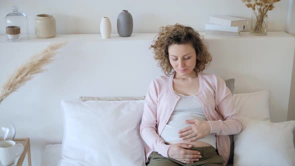 Pregnancy Concept. Pregnant Female Resting At Home In Bed.