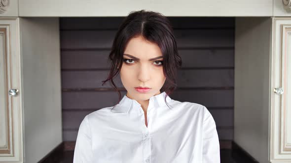 Portrait of Unhappy Hispanic Housewife Woman Looking at Camera with Serious Expression on Face