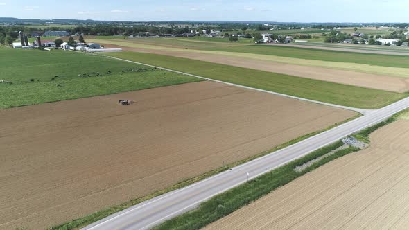 Aerial View of Amish Farm Worker Harvesting Spring Crop With Team of 6 Horses