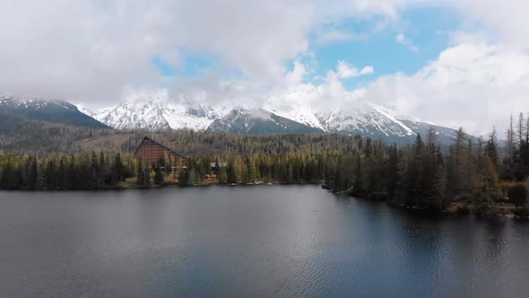 Aerial View of Strbske Pleso, Slovakia. Mountain Lake in Clouds and Snowy Tatras Mountains