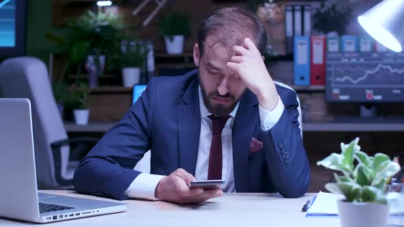 Tired Businessman Late at Night in the Office