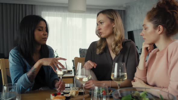 Three female caucasian and mixed race friends chatting over problems at home. Shot with RED helium c