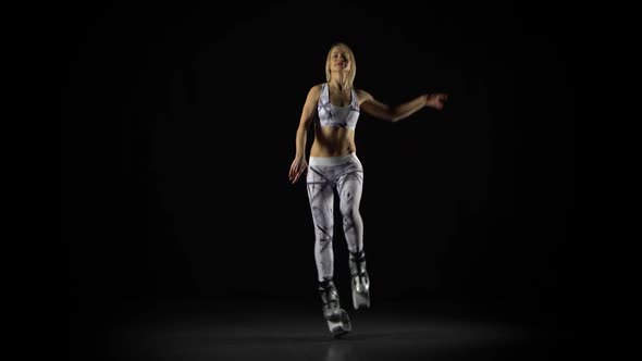 Sportswoman Is Performing Exercises in Kangoo Jumps Shoes at Studio