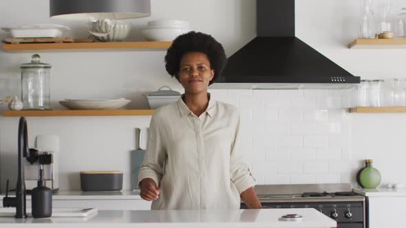 Portrait of happy african american woman in kitchen