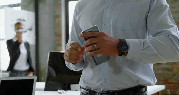 Executive using smartwatch in office 4k