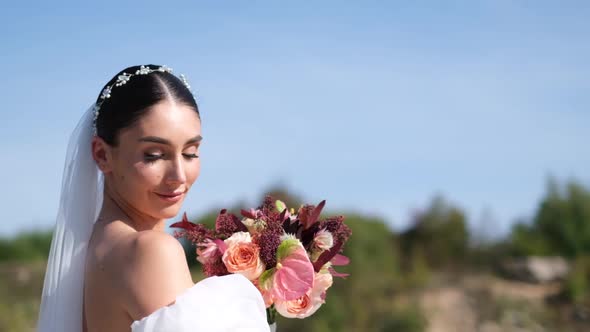 Beautiful Brunette Bride with Autumn Bouquet of Flowers