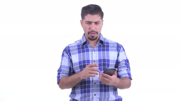 Stressed Bearded Persian Hipster Man Using Phone and Getting Bad News