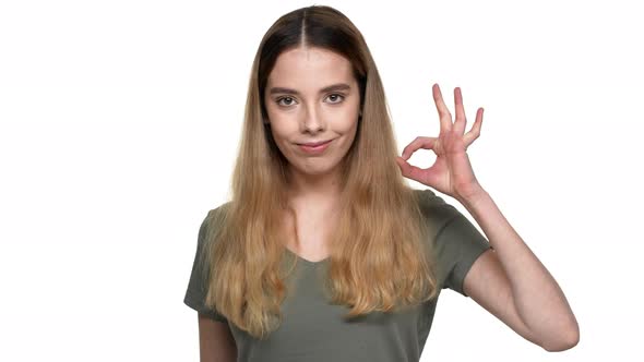 Portrait of Caucasian Woman 20s in Casual Clothing Smiling and Showing Ok Sign with Fingers Isolated