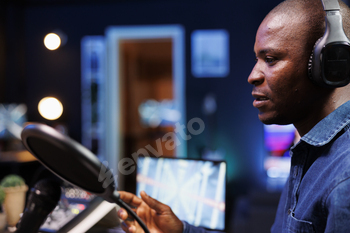 Black man recording a radio show