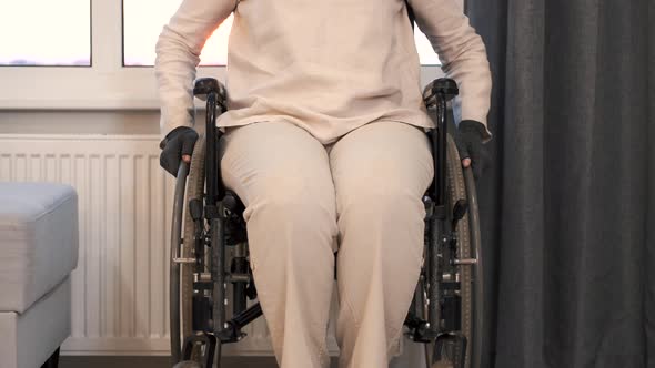 Senior Woman Trying to Sit Down in Wheelchair From Couch