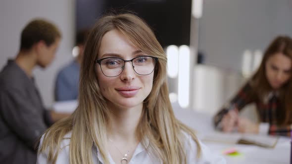 Portrait of Young Female Office Manager Looking to Camera and Having Good Mood