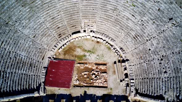 High angle drone aerial view of ancient greek rock cut lykian empire amphitheatre and tombs in Myra