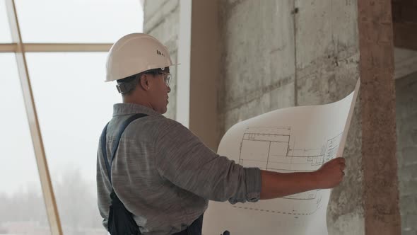 Construction Specialist Holding Building Plan
