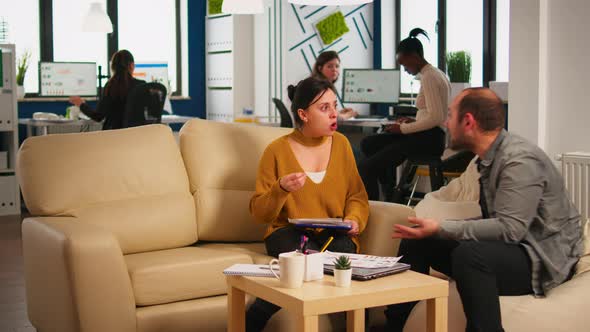 Nervous Businesspeople Yealing at Each Other Sitting on Couch