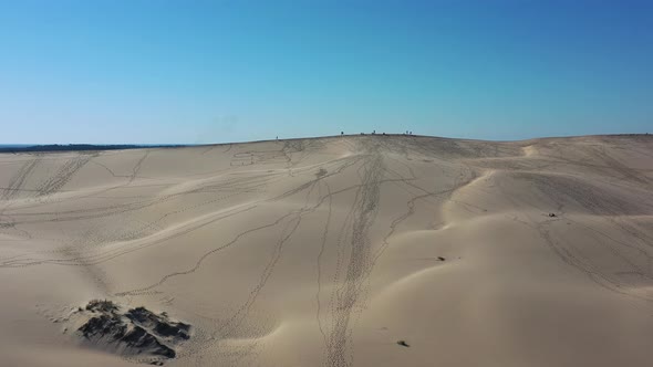 Dune du Pilat Sandhill in France with People walking along the top with footprints marked in the san