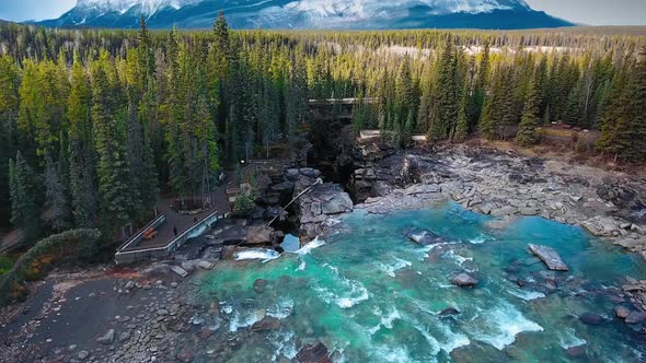 Drone captures the mountain, forest and cliff of Athabaska Falls on Athabaska River, Alberta, Canada