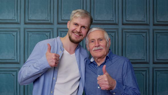 Happy Different Male Generations Family of Senior Father and Adult Son or Grandson Showing Thumbs Up
