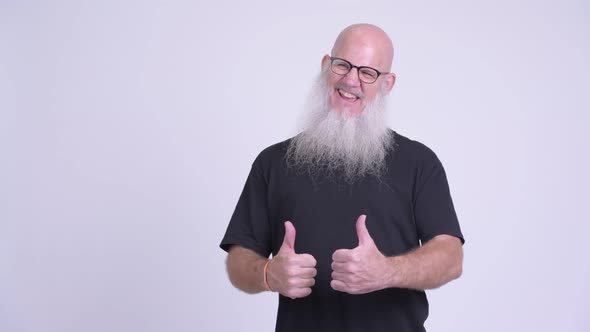 Happy Mature Bald Bearded Man Looking Excited While Giving Thumbs Up