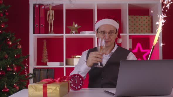 Employee Has Fun at Online Christmas Party with Champagne and Firework Fountain