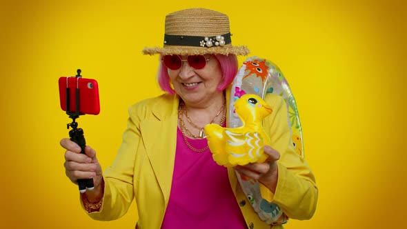 Mature Grandmother Traveler Blogger in Sunglasses Taking Selfie on Mobile Phone Video Call Online