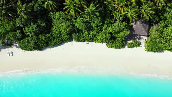 Beautiful aerial copy space shot of a sandy white paradise beach and turquoise sea background in hig