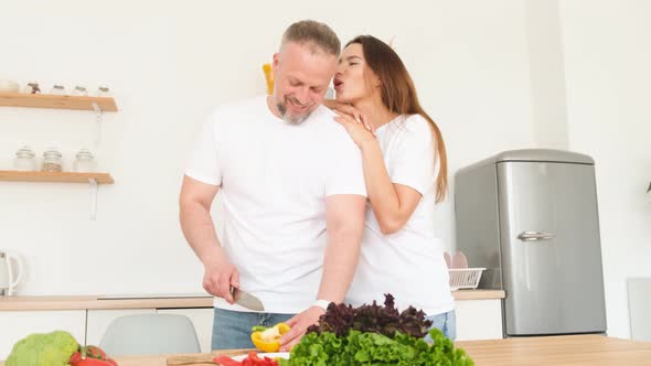 The Husband Prepares Vegetarian Food for His Wife She Hugs Him Tenderly