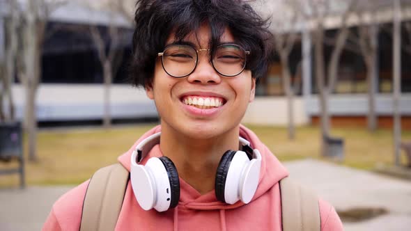 Close Up Shot of Cheerful Happy Asian Teenage Boy Looking at Camera Smiling