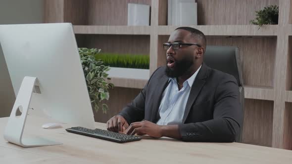 African American Businessman Looks Puzzled and Shocked Checking Emails Showing Disappointment