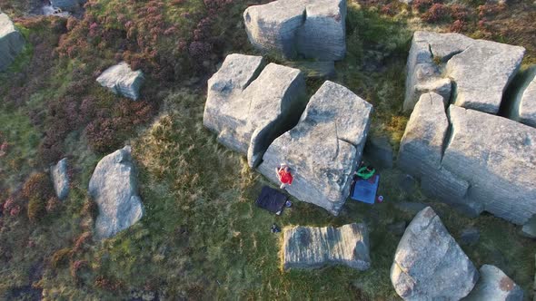 Aerial shot of men climbing boulders while bouldering.