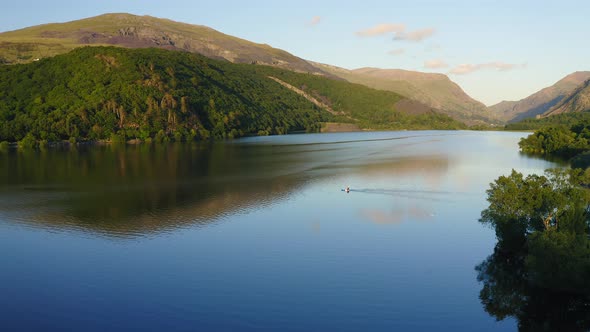 Tranquil Scene of One Boat on Lake at Snowdonia National Park in Wales - Aerial Drone